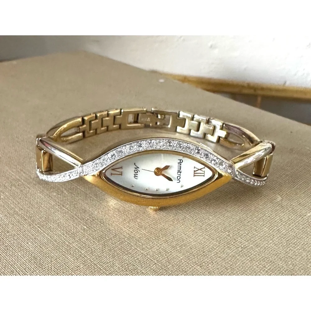 Armitron Now women's,gold-tone oval case with crystal accents and a two-tone
